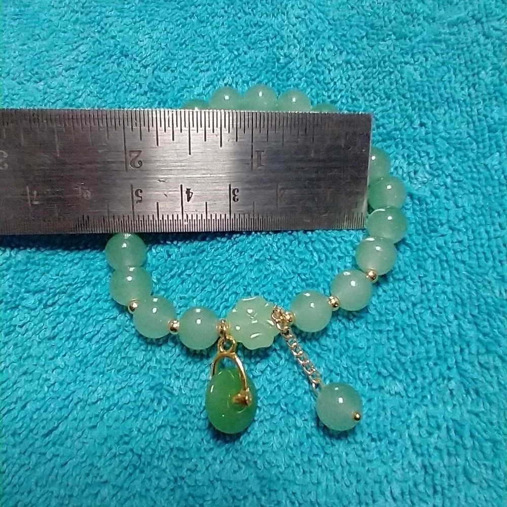 Goldtone green faux jade wheel stretch bracelet